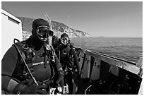 Scuba divers in wetsuits ready to dive from boat, Santa Cruz Island. Channel Islands National Park, California, USA. (black and white)