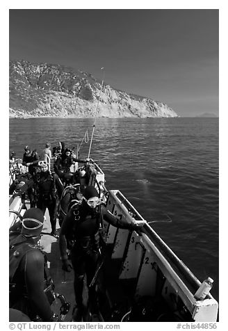 Divers in full wetsuits on diving boat, Santa Cruz Island. Channel Islands National Park (black and white)