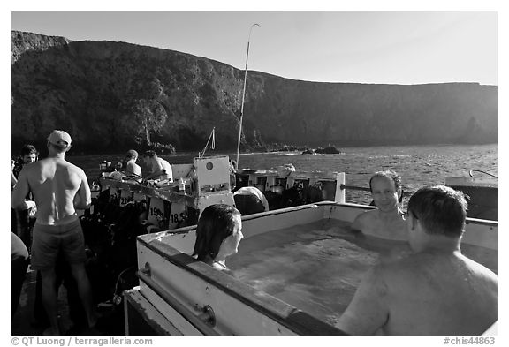 Divers relaxing in hot tub aboard the Spectre and Annacapa Island. Channel Islands National Park (black and white)