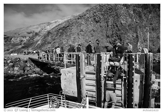 Unloading via human chain, Scorpion Anchorage, Santa Cruz Island. Channel Islands National Park (black and white)