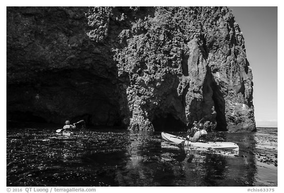 Kayaking towards sea cave, Santa Cruz Island. Channel Islands National Park (black and white)