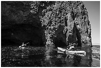 Kayaking towards sea cave, Santa Cruz Island. Channel Islands National Park ( black and white)