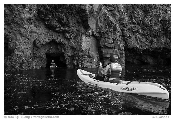 Kayakers entering sea cave, Santa Cruz Island. Channel Islands National Park (black and white)