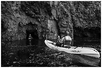 Kayakers entering sea cave, Santa Cruz Island. Channel Islands National Park ( black and white)