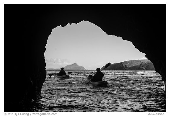 Kayakers exiting sea cave with West Anacapa in the distance, Santa Cruz Island. Channel Islands National Park (black and white)