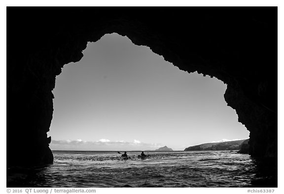 Looking out sea cave entrance with distant sea kayakers, Santa Cruz Island. Channel Islands National Park (black and white)