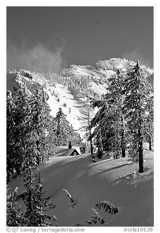Cabin in winter with trees and mountain. Crater Lake National Park (black and white)