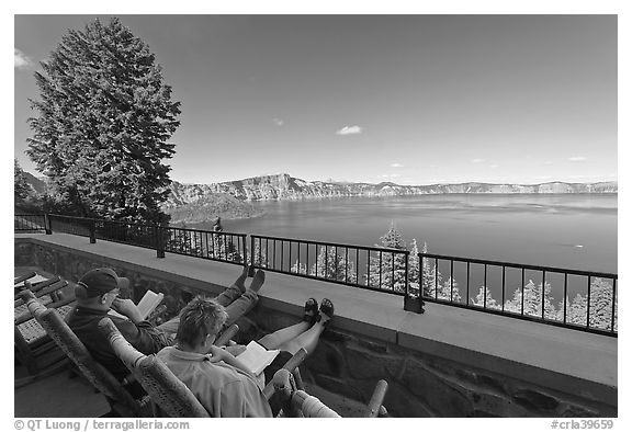 Reading on Crater Lake Lodge Terrace overlooking  Lake. Crater Lake National Park (black and white)