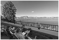 Reading on Crater Lake Lodge Terrace overlooking  Lake. Crater Lake National Park ( black and white)