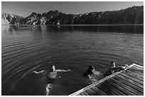 Girls swim from Wizard Island dock. Crater Lake National Park ( black and white)