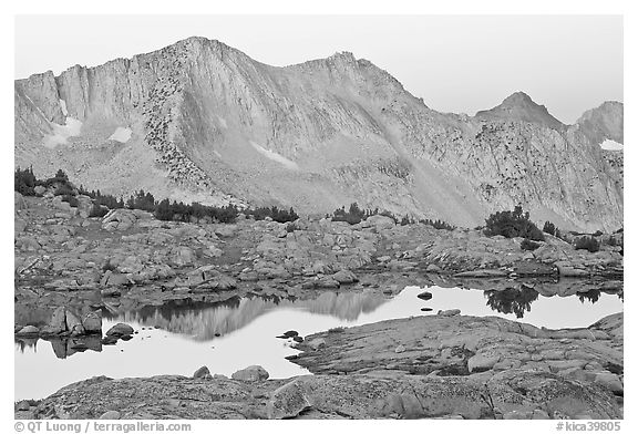 Mountains reflected in calm alpine lake at dawn, Dusy Basin. Kings Canyon National Park (black and white)