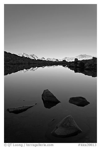 Rocks and calm lake with mountain reflections, early morning, Dusy Basin. Kings Canyon National Park (black and white)