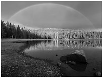 Rainbow in dark sky above Juniper Lake. Lassen Volcanic National Park ( black and white)
