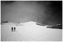 Mountaineers climbing a snow field on Sahale Peak,  North Cascades National Park. Washington, USA. (black and white)