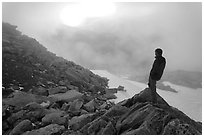 Visitor on ridge waches foggy sunset, North Cascades National Park.  ( black and white)
