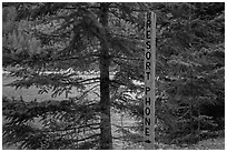 Sign pointing to phone used to call Ross Lake resort, North Cascades National Park Service Complex.  ( black and white)