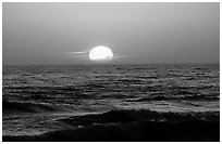 Disc of sun setting in  pacific, Shi-shi beach. Olympic National Park, Washington, USA. (black and white)