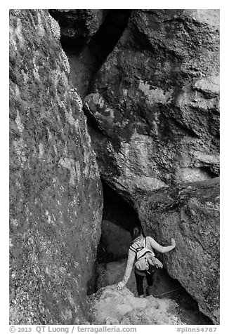 Woman walking into Balconies Cave. Pinnacles National Park (black and white)