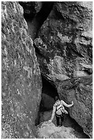 Woman walking into Balconies Cave. Pinnacles National Park, California, USA. (black and white)