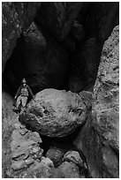 Man with headlamp looking up in Balconies Cave. Pinnacles National Park ( black and white)