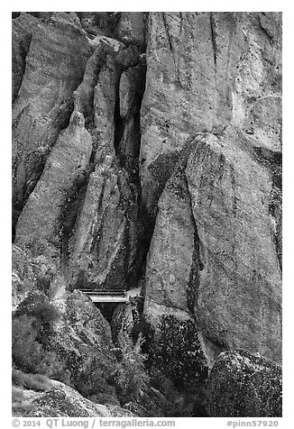Footbridge at Tunnel exit dwarfed by rock towers. Pinnacles National Park (black and white)