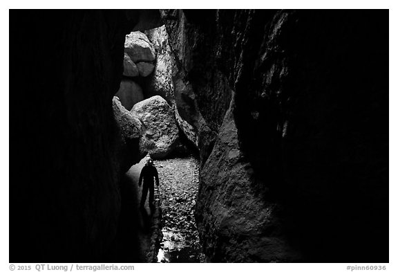 Hiker with lamp in Bear Gulch Cave. Pinnacles National Park (black and white)