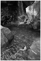 Girl swims in cool pool at the base of Wapama falls. Yosemite National Park, California, USA. (black and white)