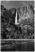 Man paddling in flooded meadow below Yosemite Falls. Yosemite National Park ( black and white)