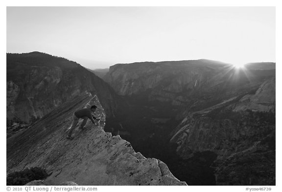 Hiker looking over the edge of the Diving Board, sunset. Yosemite National Park (black and white)