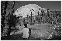 Hiker looking at backside of Half-Dome from Lost Lake. Yosemite National Park, California, USA. (black and white)