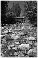 Pebbles in river and covered bridge, Wawona. Yosemite National Park, California, USA. (black and white)