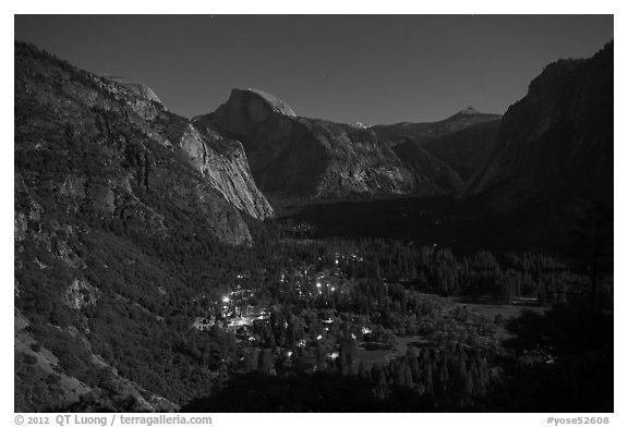 Yosemite Village lights and Half-Dome by moonlight. Yosemite National Park, California, USA.