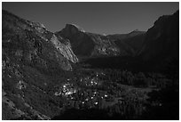 Yosemite Village lights and Half-Dome by moonlight. Yosemite National Park, California, USA. (black and white)