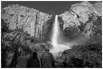Tourists looking at Bridalvail Fall rainbow. Yosemite National Park, California, USA. (black and white)