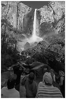 Tourists standing below Bridalvail Fall. Yosemite National Park, California, USA. (black and white)