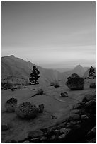 Glacial erratics, pine trees, Clouds rest and Half-Dome from Olmstedt Point, sunset. Yosemite National Park, California, USA. (black and white)