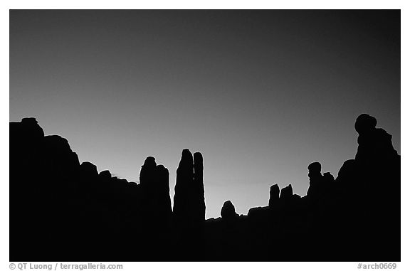 Sandstone pillars in Klondike Bluffs seen as silhouettes at dusk. Arches National Park (black and white)