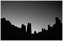 Sandstone pillars in Klondike Bluffs seen as silhouettes at dusk. Arches National Park, Utah, USA. (black and white)