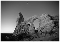 Turret Arch and moon, dawn. Arches National Park, Utah, USA. (black and white)