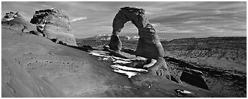 Red sandstone of Delicate Arch and blue shades of snow. Arches National Park (Panoramic black and white)