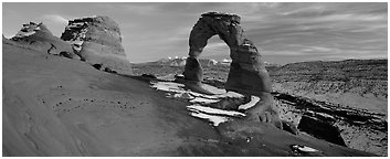 Desert Arch and mountains at sunset. Arches National Park (Panoramic black and white)