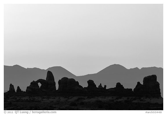 Turret Arch, spires, and mountains at dawn. Arches National Park (black and white)