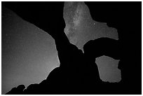 Double Arch with starry sky and Milky Way. Arches National Park, Utah, USA. (black and white)