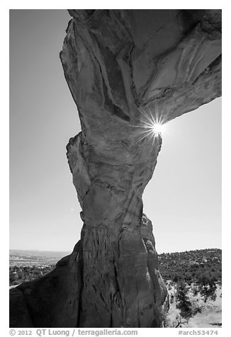 Sunburst at the crack of Broken Arch. Arches National Park (black and white)