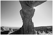 Broken Arch seen from below with sunburst at the crack. Arches National Park, Utah, USA. (black and white)