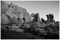 Cove of Arches, Double Arch, and Parade of Elephants at dusk. Arches National Park, Utah, USA. (black and white)