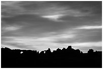 Windows and Turret Arch silhouetted at sunrise. Arches National Park, Utah, USA. (black and white)