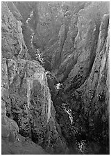 View down steep rock walls and narrow chasm. Black Canyon of the Gunnison National Park, Colorado, USA. (black and white)