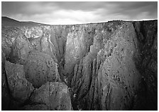 Narrow gorge under dark clouds. Black Canyon of the Gunnison National Park ( black and white)