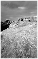 Sandstone striations and Needles near Elephant Hill, sunrise. Canyonlands National Park, Utah, USA. (black and white)